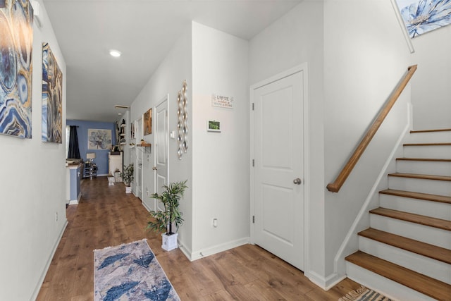 hallway with hardwood / wood-style flooring