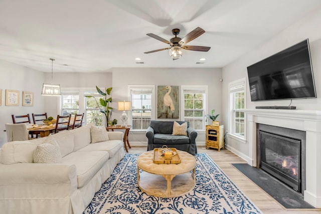 living room featuring ceiling fan and light wood-type flooring