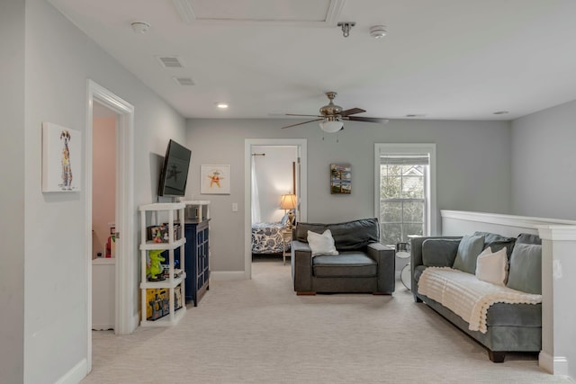 living room featuring ceiling fan and light colored carpet