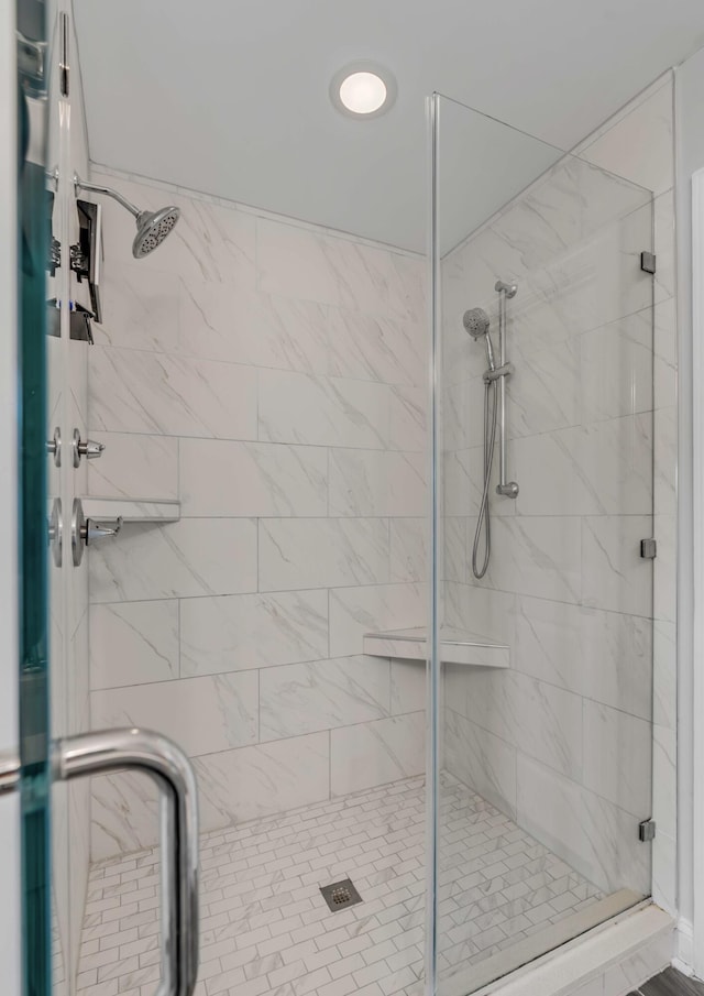 bathroom featuring a shower with shower door