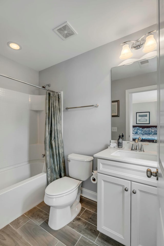 full bathroom featuring toilet, vanity, and shower / tub combo with curtain