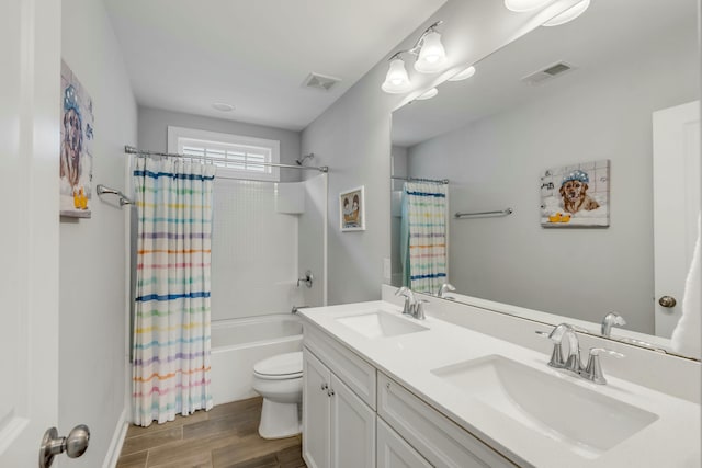 full bathroom with toilet, vanity, and shower / tub combo with curtain