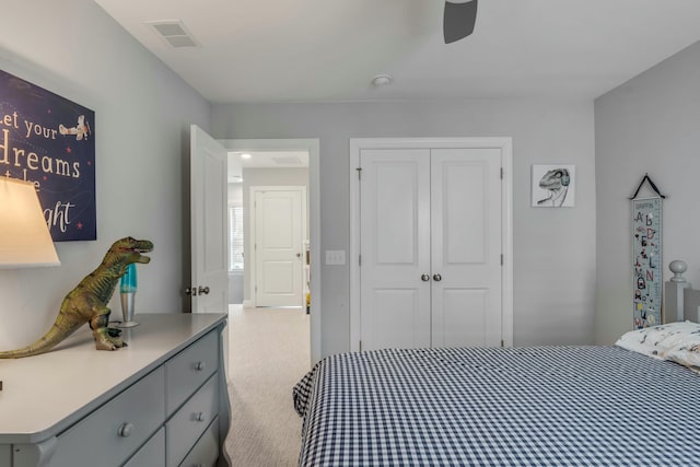 bedroom featuring a closet, ceiling fan, and light colored carpet