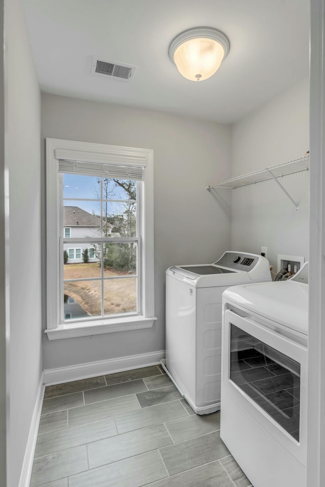 laundry room featuring washing machine and clothes dryer