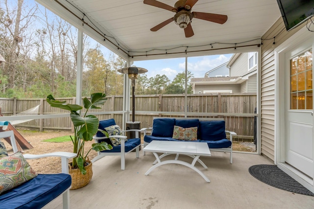 sunroom featuring ceiling fan