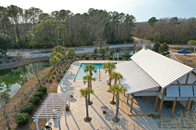 view of swimming pool with a water view and a patio area