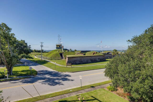 view of property's community with a yard