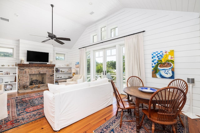 living room featuring lofted ceiling, hardwood / wood-style floors, and a wealth of natural light