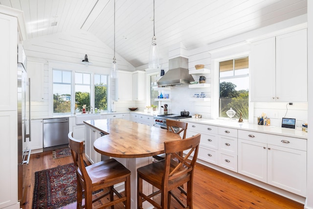 kitchen featuring appliances with stainless steel finishes, white cabinetry, and plenty of natural light