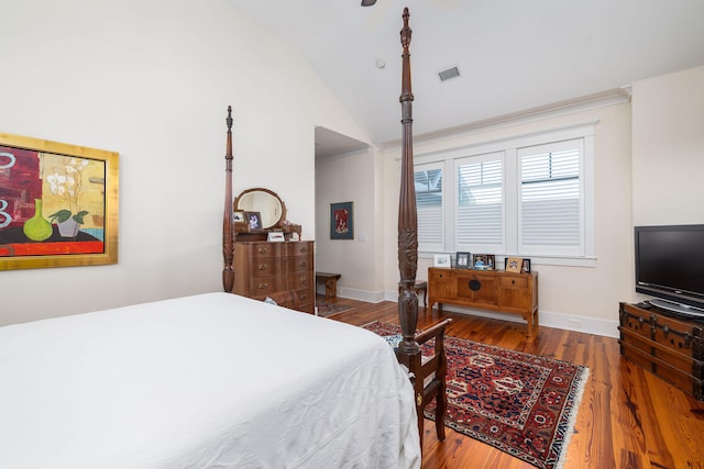 bedroom with high vaulted ceiling and hardwood / wood-style floors