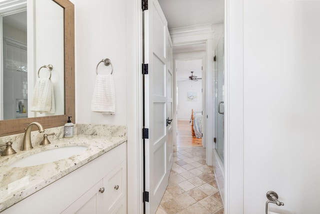 bathroom with vanity, an enclosed shower, and ceiling fan