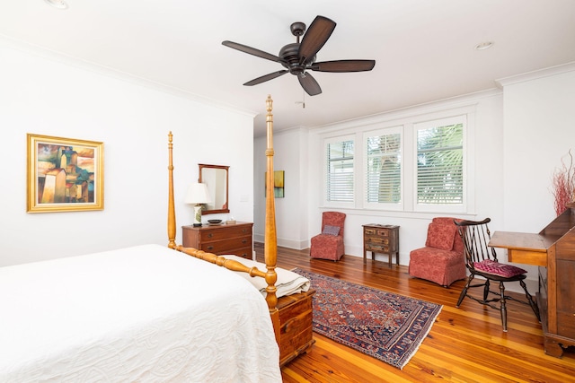 bedroom featuring ornamental molding, hardwood / wood-style flooring, and ceiling fan