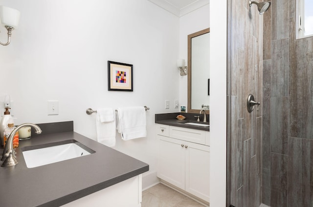 bathroom featuring vanity, ornamental molding, and a tile shower