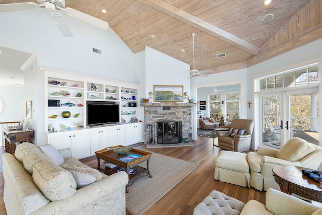 living room featuring high vaulted ceiling, wood finished floors, french doors, wooden ceiling, and a fireplace