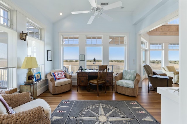 interior space featuring a healthy amount of sunlight, wood finished floors, visible vents, and high vaulted ceiling