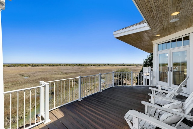 wooden terrace featuring a rural view and french doors