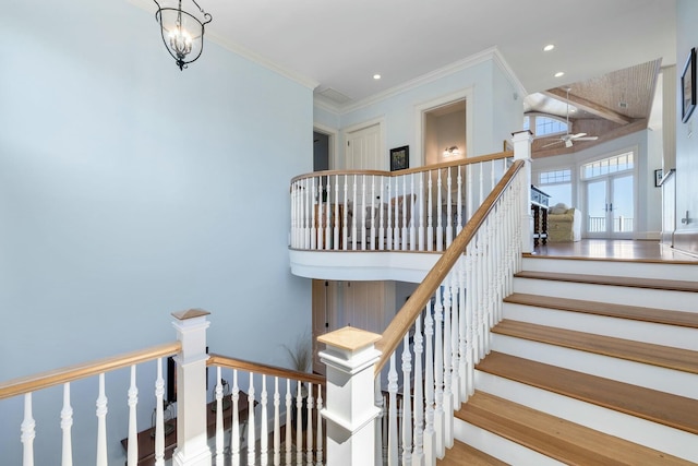 stairs with a chandelier, recessed lighting, and crown molding