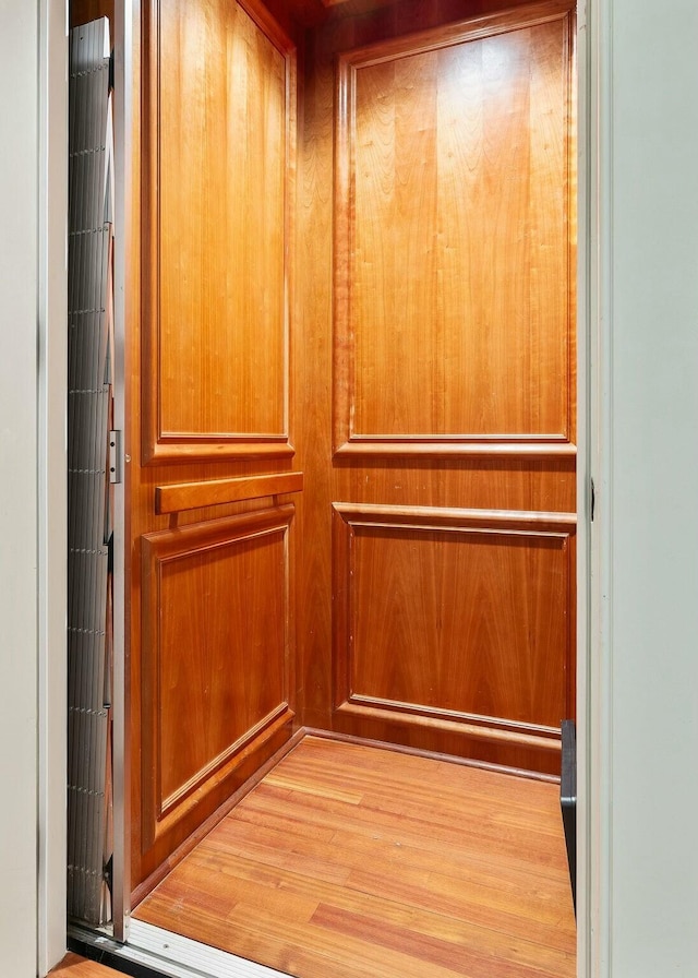 interior details with elevator and wood finished floors