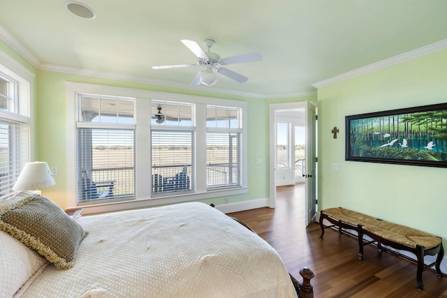 bedroom with dark wood-type flooring, a ceiling fan, baseboards, and ornamental molding