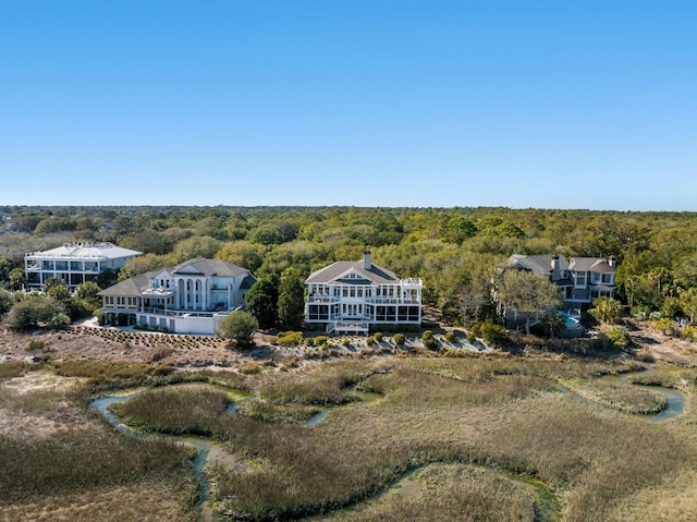 drone / aerial view with a wooded view