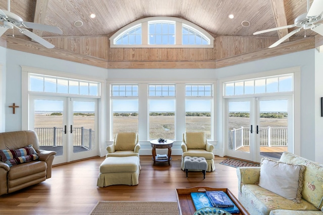 sunroom featuring french doors, lofted ceiling, ceiling fan, and wooden ceiling