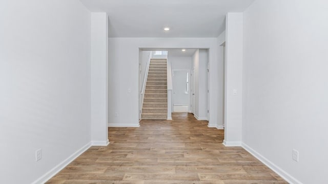 hallway with light hardwood / wood-style floors