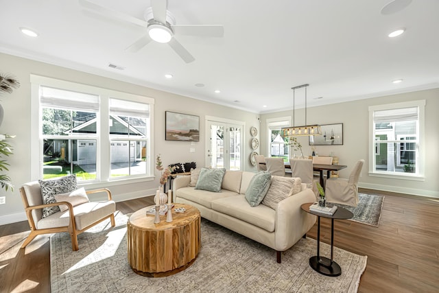 living room featuring ornamental molding, hardwood / wood-style floors, and ceiling fan