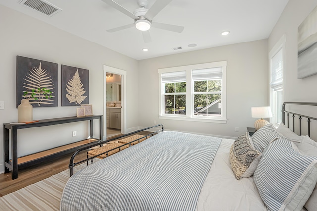 bedroom with ceiling fan, hardwood / wood-style flooring, and connected bathroom