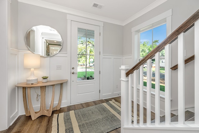 foyer featuring ornamental molding and dark hardwood / wood-style floors