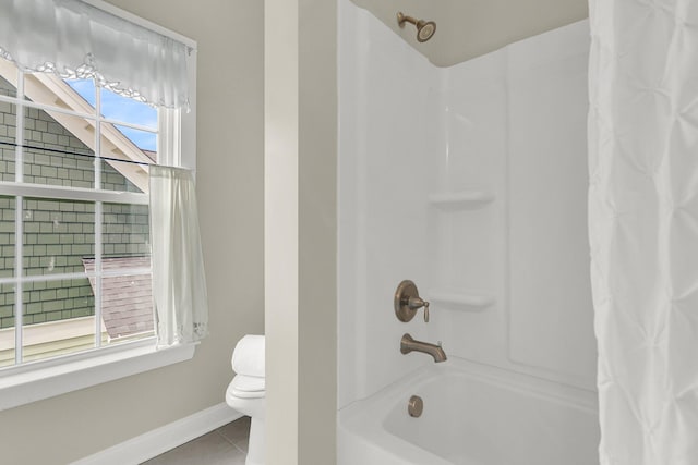 bathroom with tile patterned floors, shower / bath combination with curtain, and toilet