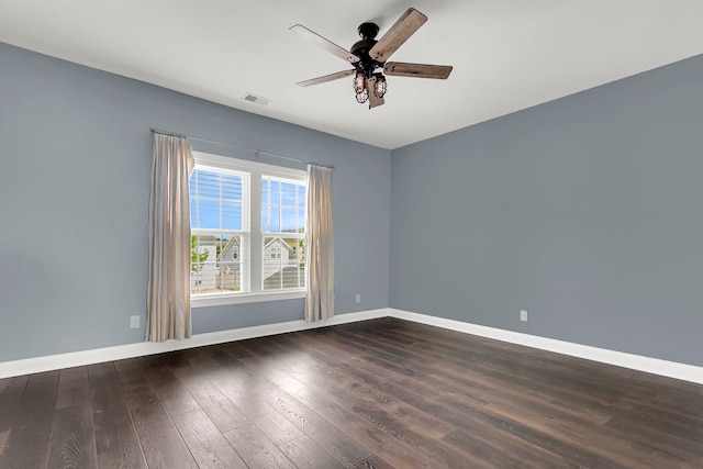 empty room featuring ceiling fan and dark hardwood / wood-style flooring