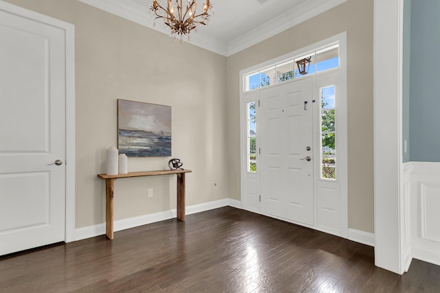 entryway featuring ornamental molding, dark hardwood / wood-style floors, and an inviting chandelier