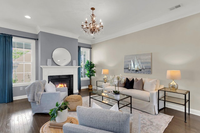 living room with a chandelier, ornamental molding, and dark wood-type flooring