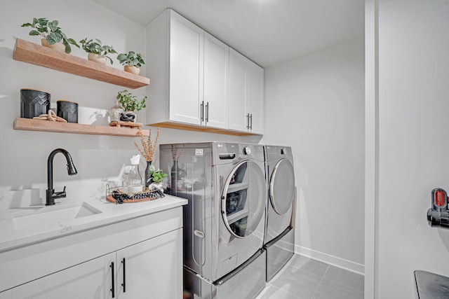 445 Oswego Ct, Greenville, SC 29607 - laundry room with washer and clothes dryer, baseboards, light tile patterned floors, and cabinet space