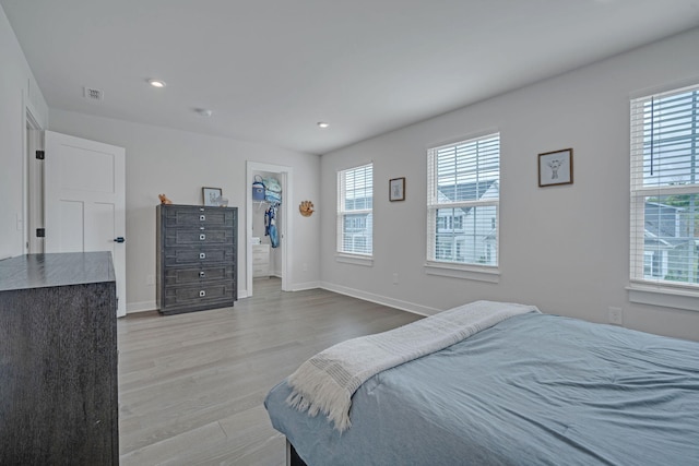 445 Oswego Ct, Greenville, SC 29607 - bedroom featuring multiple windows, light wood-style flooring, a walk in closet, and recessed lighting
