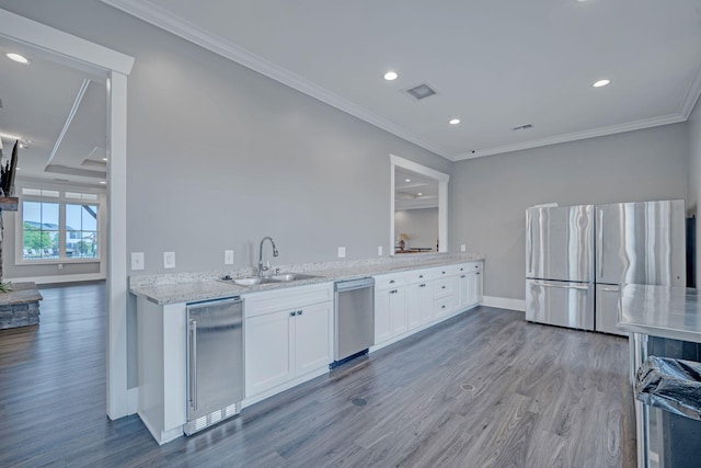 445 Oswego Ct, Greenville, SC 29607 - kitchen with stainless steel appliances, a sink, beverage cooler, light wood-type flooring, and white cabinets