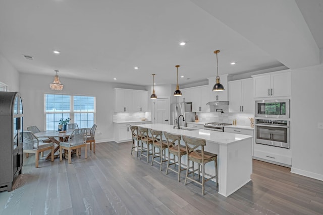 445 Oswego Ct, Greenville, SC 29607 - kitchen with appliances with stainless steel finishes, a sink, tasteful backsplash, wood finished floors, and recessed lighting