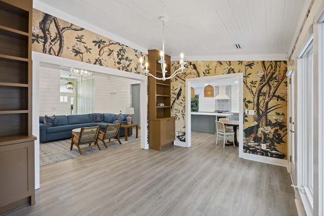 1075 Wayfarer Ln, Charleston, SC 29412 - living room featuring a chandelier, wallpapered walls, and light wood-type flooring
