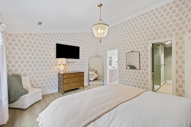 1075 Wayfarer Ln, Charleston, SC 29412 - bedroom with wood finished floors, wallpapered walls, connected bathroom, and ornamental molding