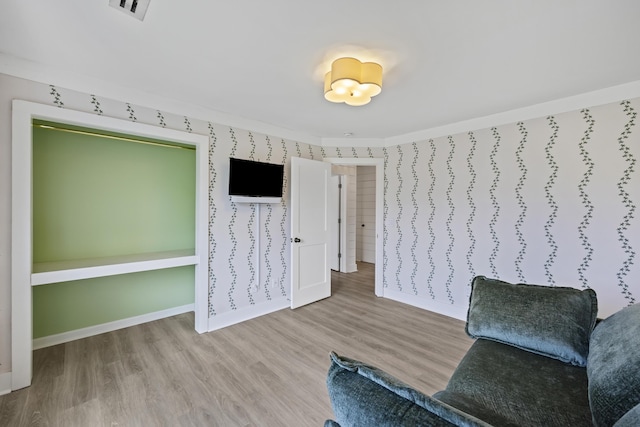 1075 Wayfarer Ln, Charleston, SC 29412 - living area with wood finished floors, ornamental molding, and wallpapered walls