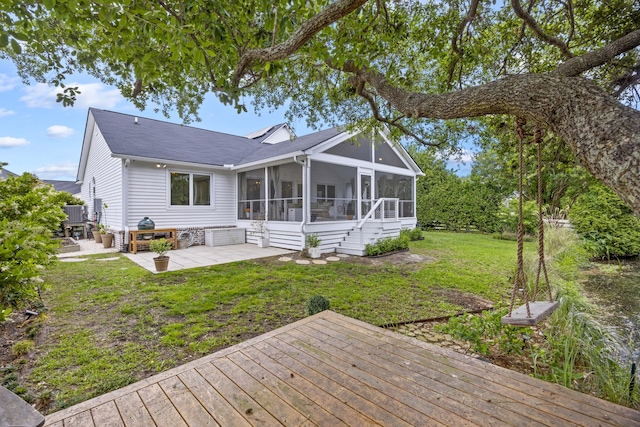 1075 Wayfarer Ln, Charleston, SC 29412 - rear view of property with a sunroom, a deck, a patio, a yard, and roof with shingles