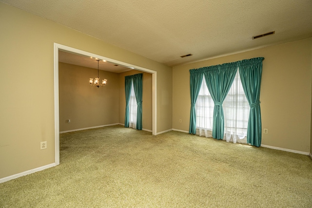 4328 Cheviot Dr, North Charleston, SC 29418 - empty room featuring a chandelier, carpet, a textured ceiling, and baseboards