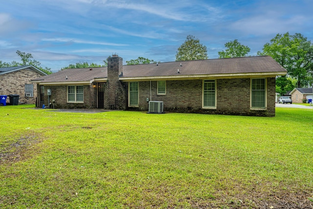 4328 Cheviot Dr, North Charleston, SC 29418 - rear view of house featuring a yard, central air condition unit, a chimney, and brick siding