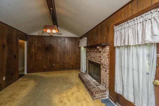 4328 Cheviot Dr, North Charleston, SC 29418 - unfurnished living room with wooden walls, a textured ceiling, a fireplace, and carpet floors