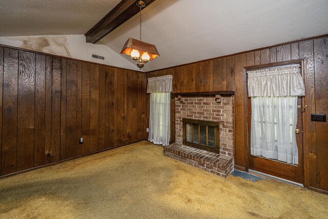 4328 Cheviot Dr, North Charleston, SC 29418 - unfurnished living room with wooden walls, carpet floors, a fireplace, and a textured ceiling