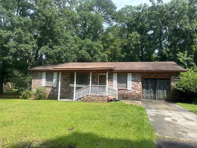 ranch-style home with a garage and a front lawn