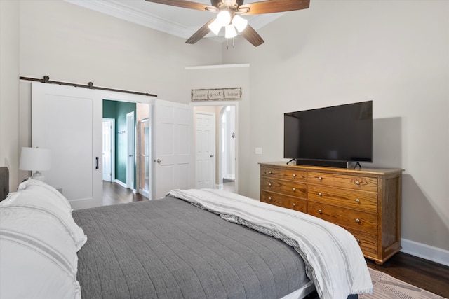 bedroom with ornamental molding, a ceiling fan, dark wood finished floors, a high ceiling, and baseboards