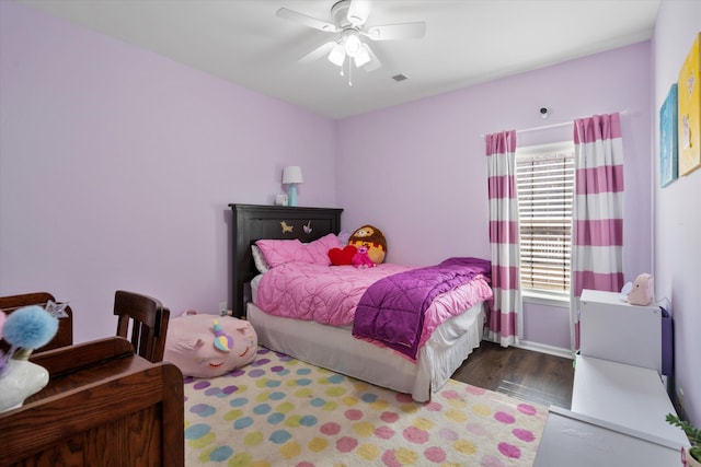 bedroom with visible vents, wood finished floors, and a ceiling fan