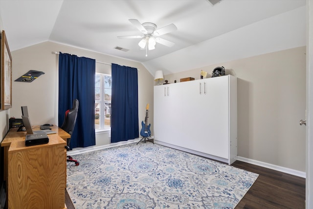 home office with wood finished floors, a ceiling fan, visible vents, baseboards, and lofted ceiling