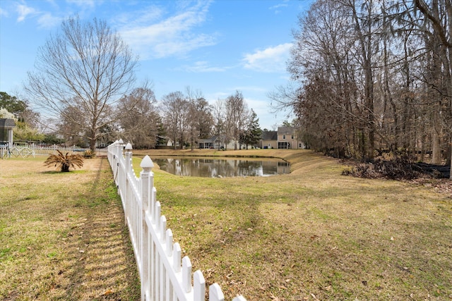 view of yard with fence and a water view